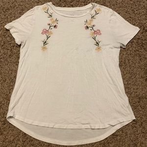 Large women's white Aero top with floral detailing.